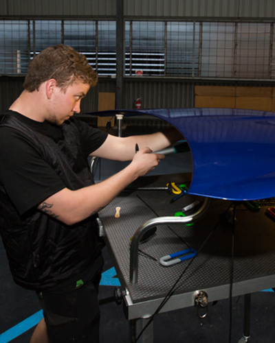 John Ashton repairing a hail damaged vehicle